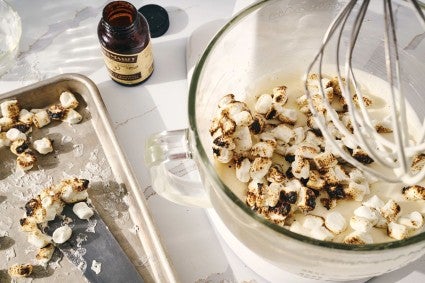 Roasted mini marshmallows added to a stand mixer bowl of whipped cream